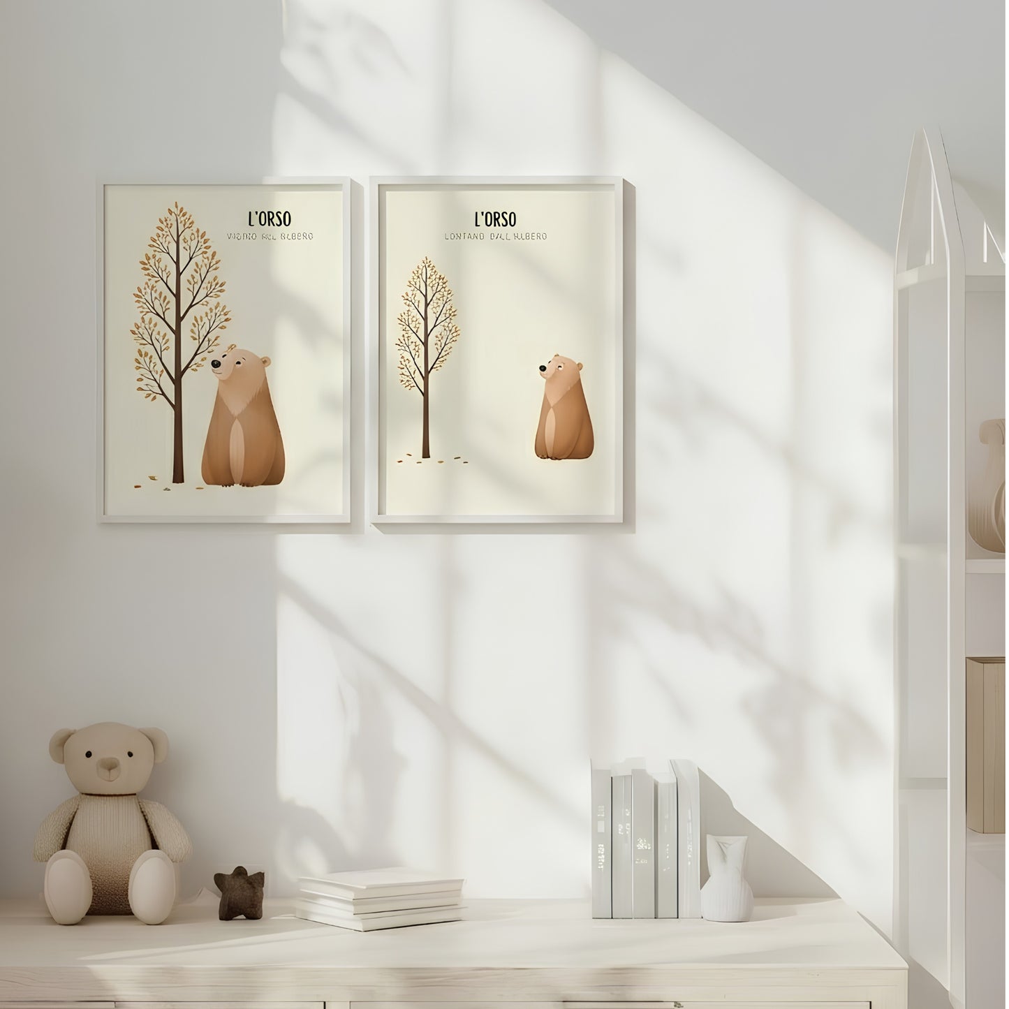 Coppia di poster illustrati con orso vicino e lontano da un albero autunnale, appesi in una cameretta per bambini luminosa dai toni chiari e naturali.